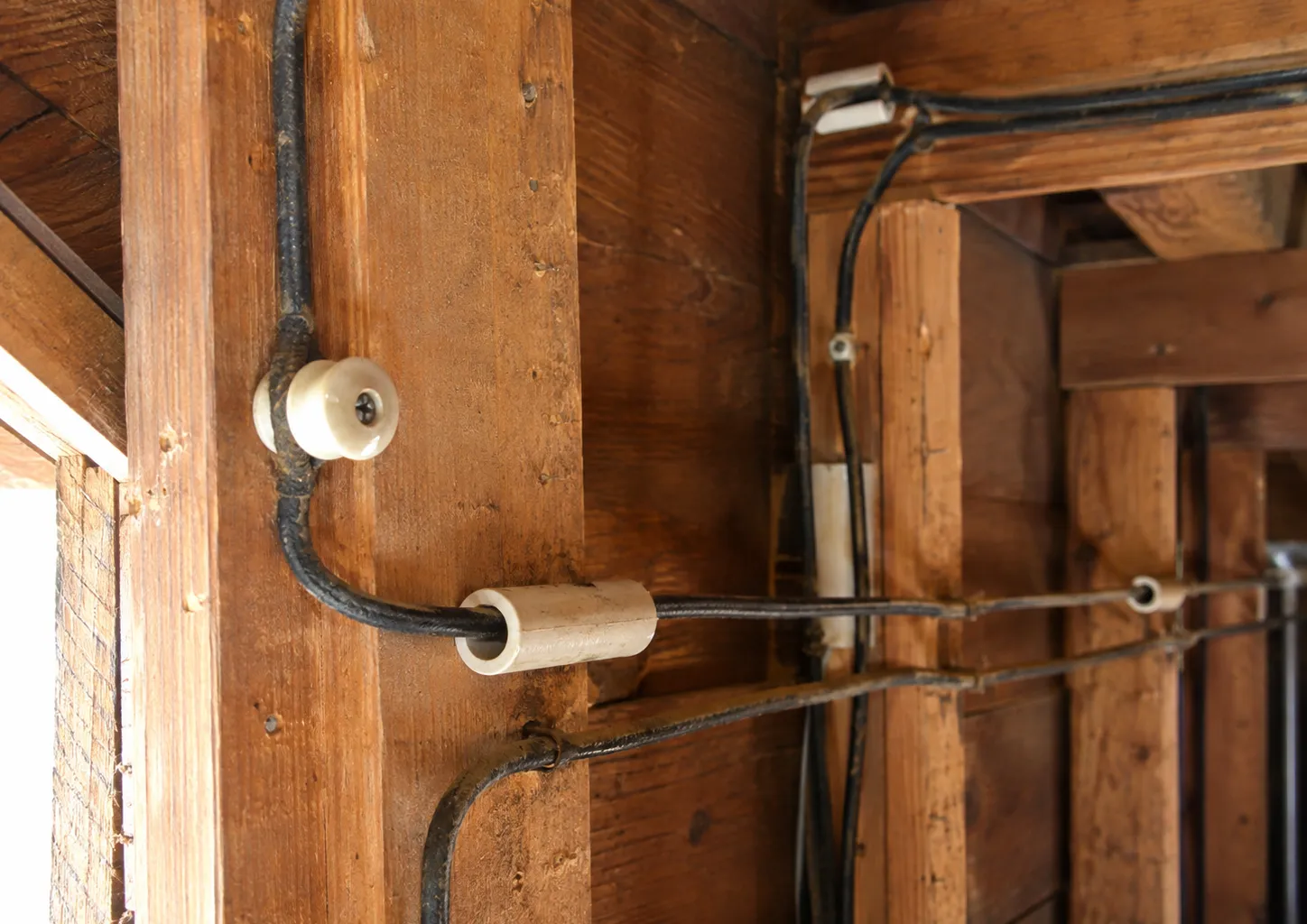 Exposed knob-and-tube wiring in an older home