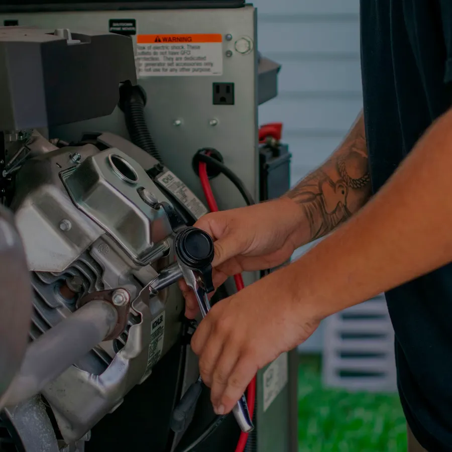 A certified technician servicing a Kohler standby generator's engine